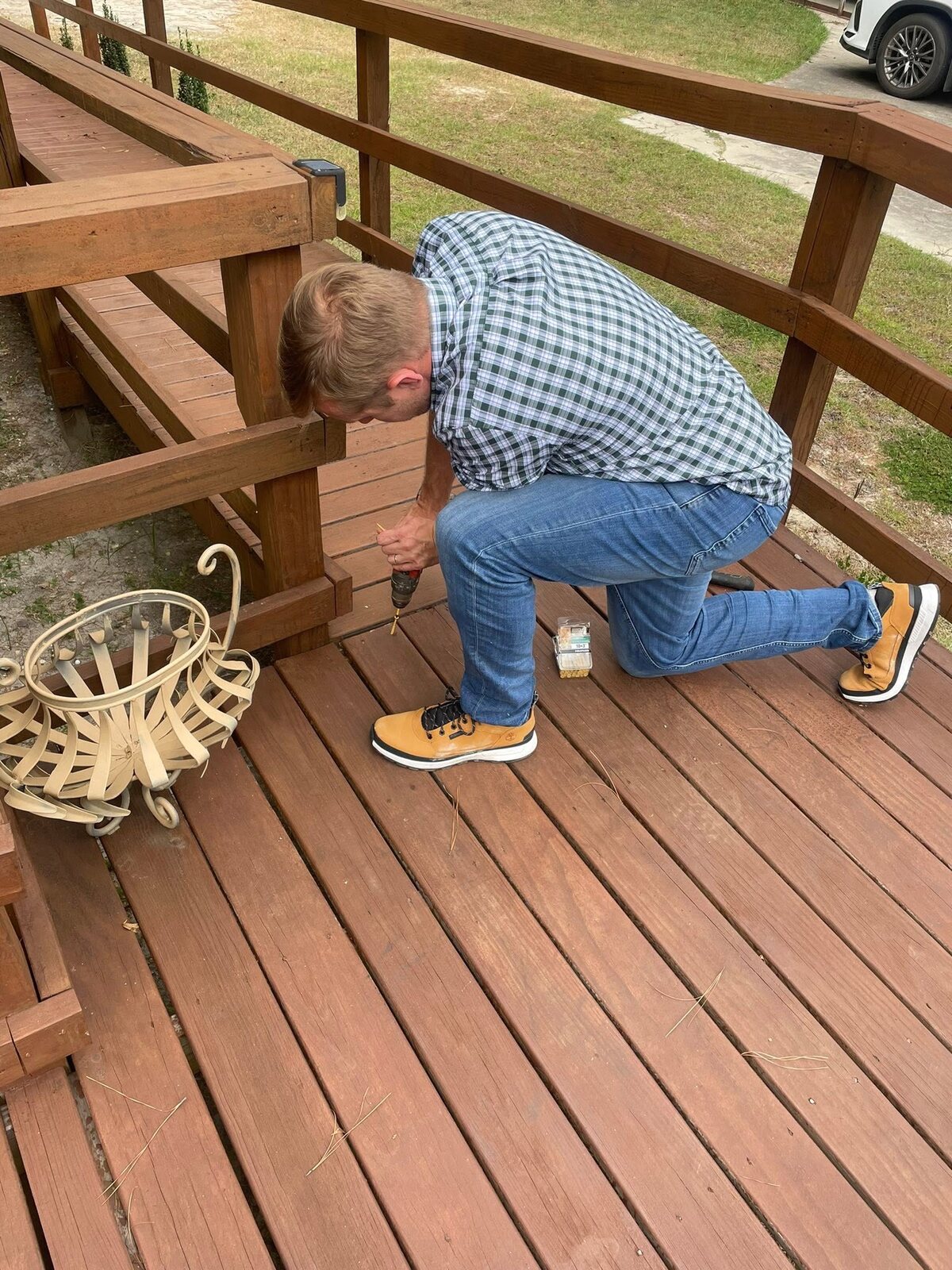 Colby Watson fixing a deck railing